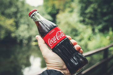 Person Holding a Coca-cola Bottle